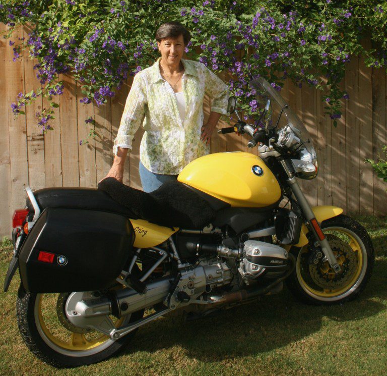 author Laura Drake next to her motorcycle